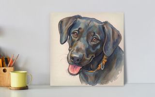 Colorful painting of a black Labrador with a yellow collar on a desk.