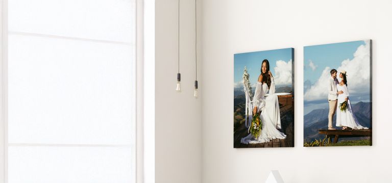 Framed wedding portraits on a wall, featuring a bride and a couple in a scenic mountain setting.