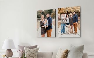 two canvas prints of a family sitting above a modern couch living room setting