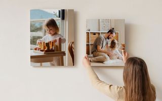 A canvas print of a small yellow car above a side table.