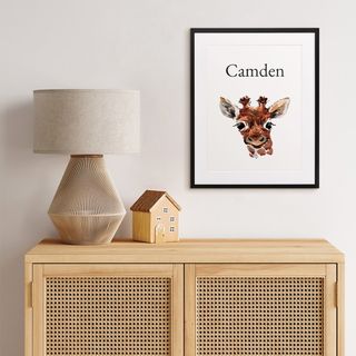 A large, colorful canvas print behind a crib.