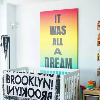 A framed print positioned above a child's bed.