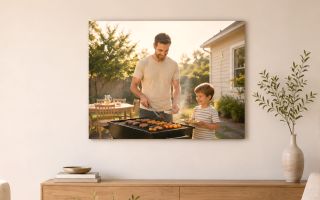 a canvas print of a dad and son grilling in the backyard. Hung in a modern, minimal room.