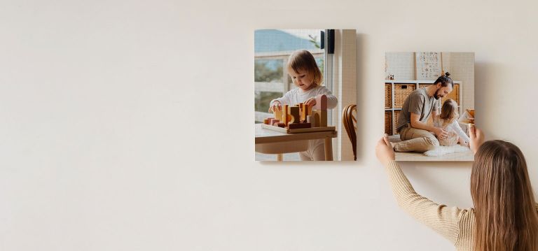 A canvas print of a small yellow car above a side table.